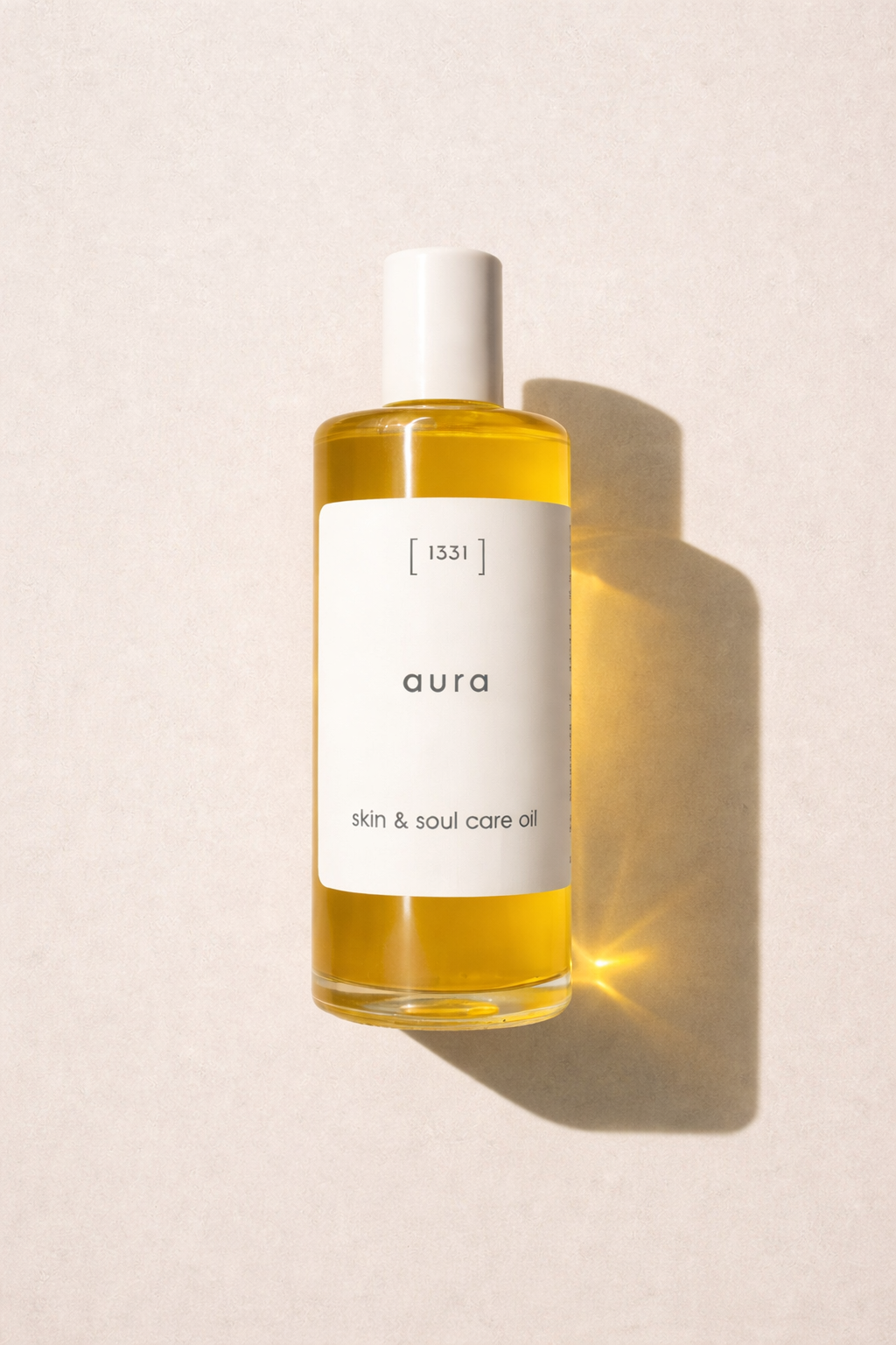 Bottle of 'aura' skin and soul care oil on a light background