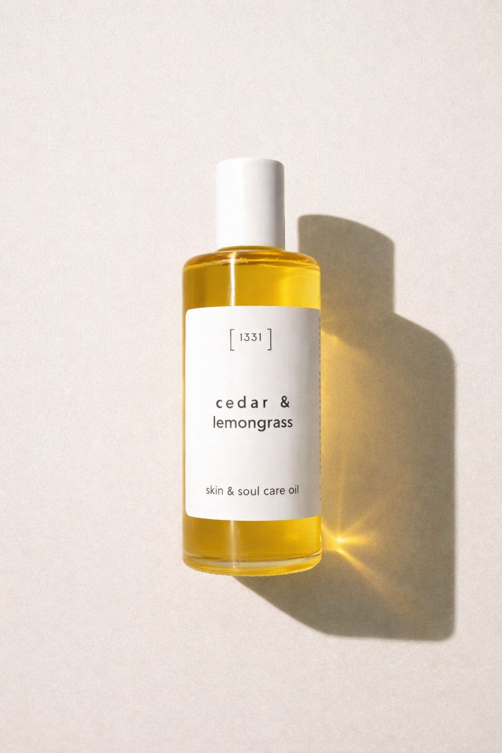 1331 Bottle of cedar & lemongrass skincare oil on a light background